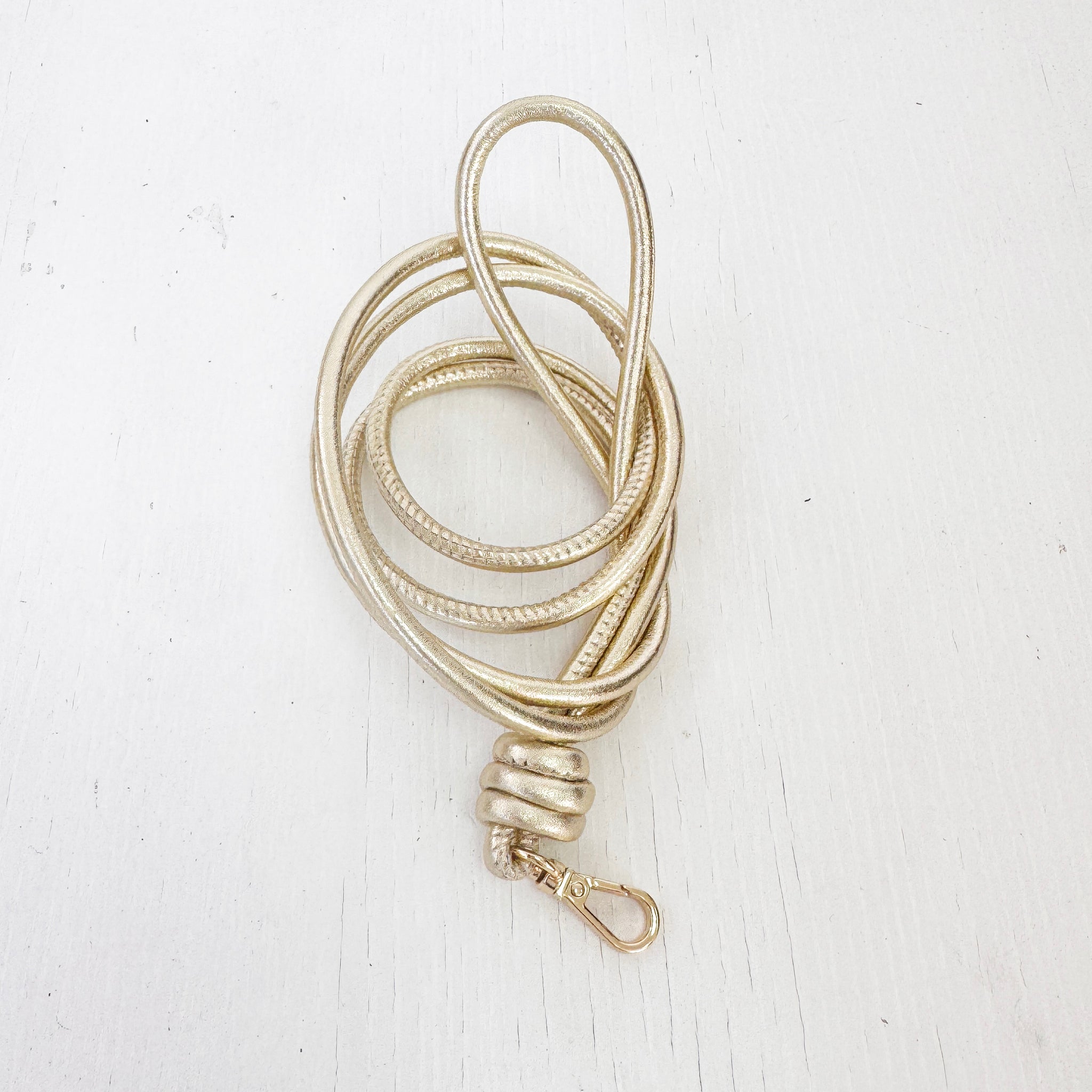 Colgador nudos móvil piel oro